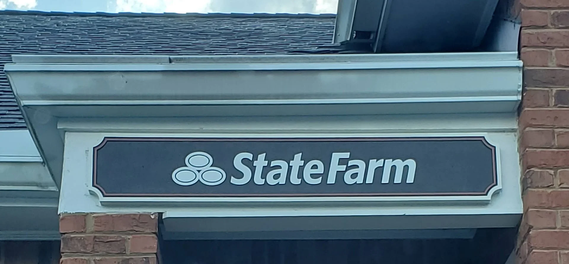 State Farm office building sign mounted on brick exterior